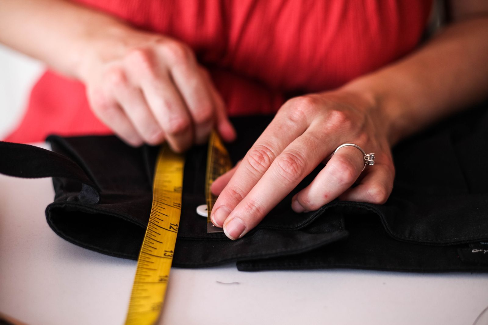 Measuring a garment detail to compare dimensions before and after shrinkage testing