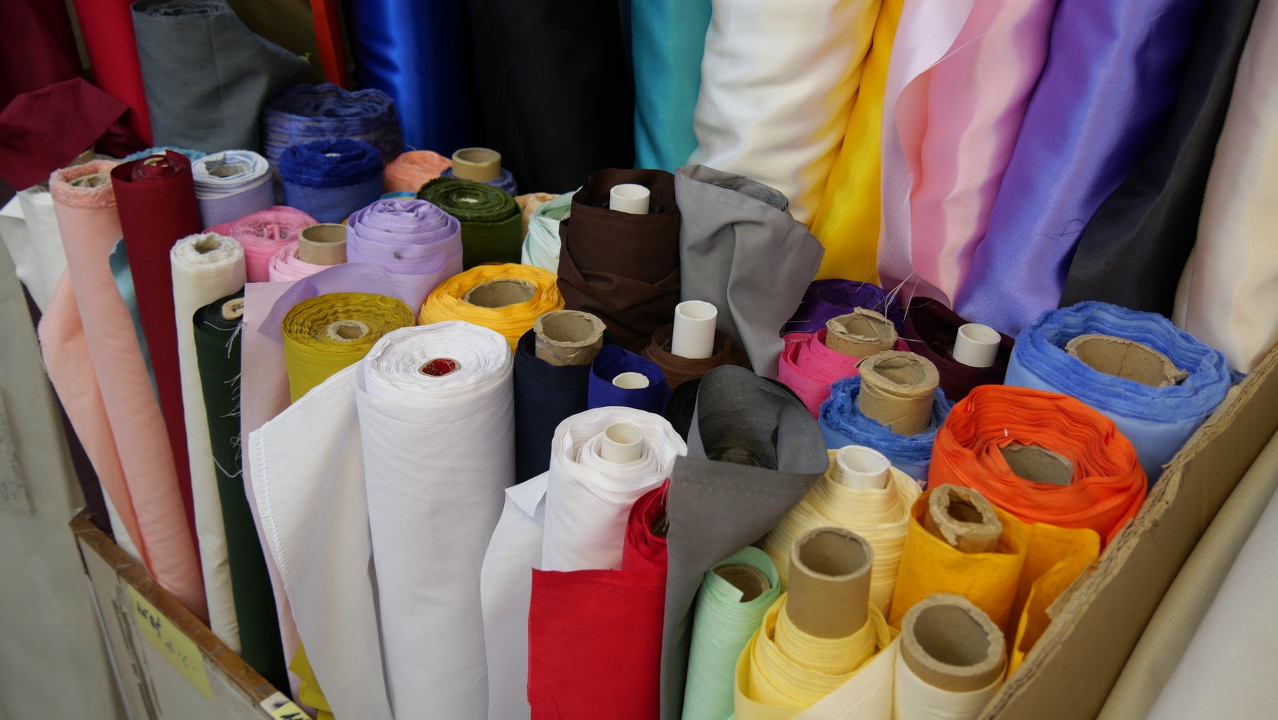 Rows of fabric rolls representing Guangzhou's textile sourcing ecosystem