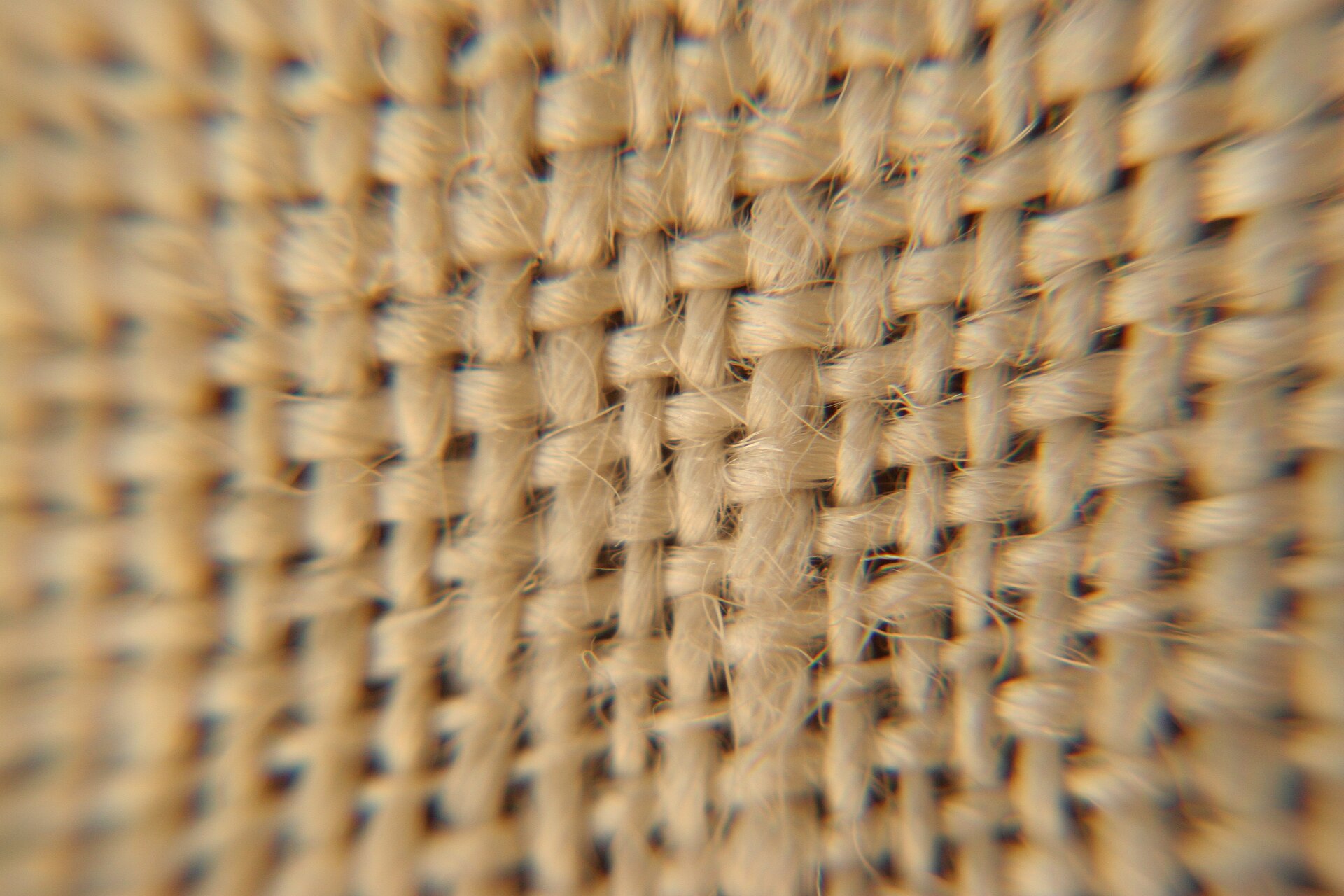 Close view of a natural linen fabric weave and irregular yarn texture