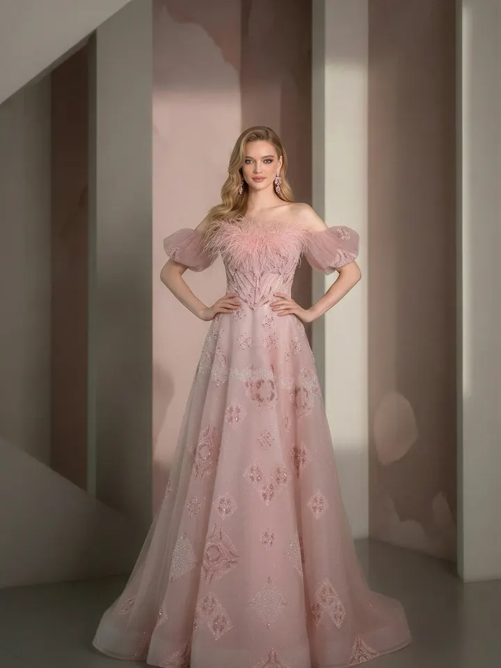 Front-facing model wearing a pink feather-trimmed evening gown