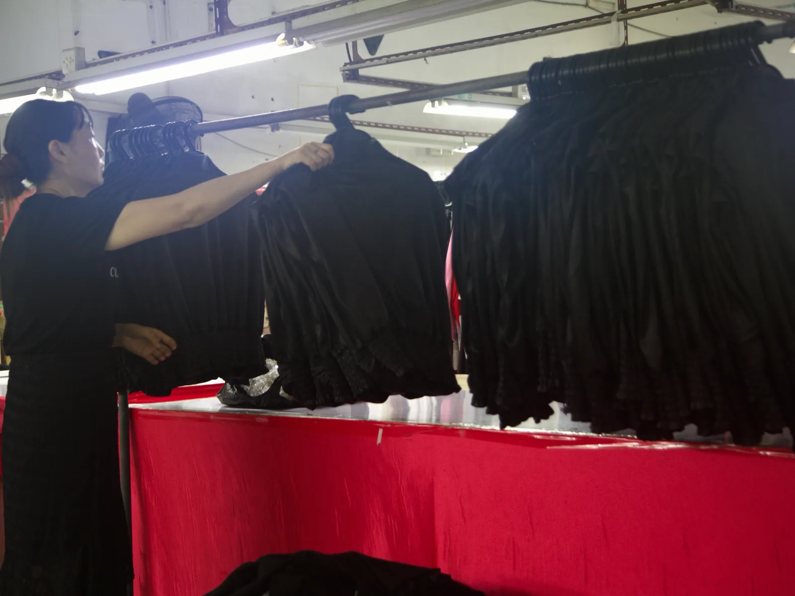 Finished garments on racks for inspection at PIPK