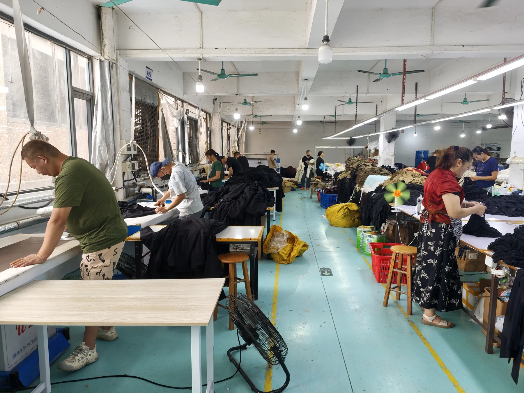 Wide view of workers and production stations across the PIPK factory floor